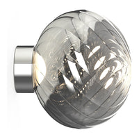 Modern glass wall lamp with a round, textured silver and clear design, featuring intricate swirling patterns.