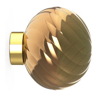 Amber glass orb with a diamond pattern and gold accent, perfect for modern decor.