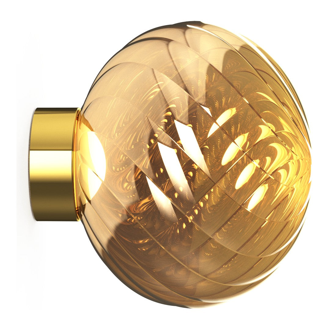 Elegant amber glass wall sconce with a swirling pattern and shiny gold metal accents. Perfect for modern decor.