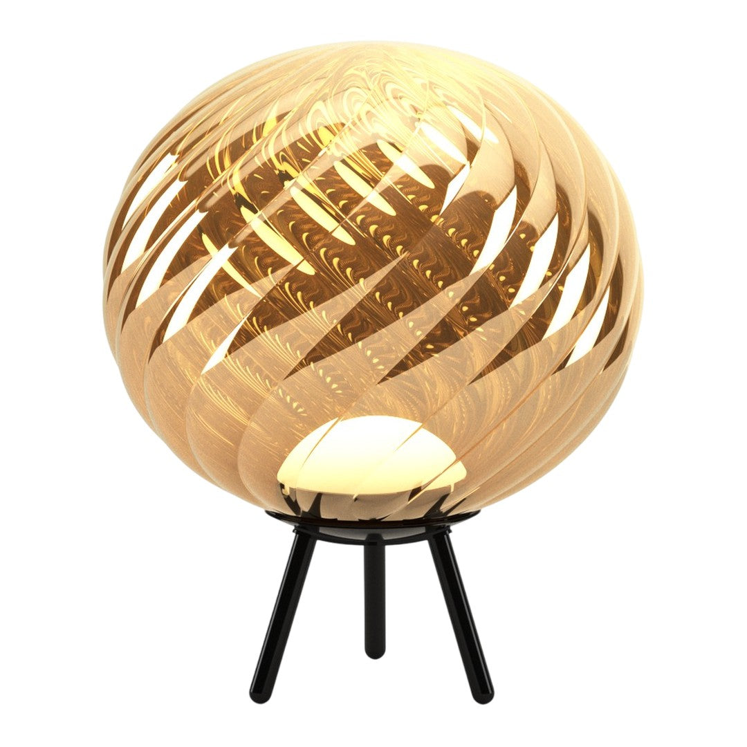 Gold globe lamp with swirling amber patterns on a black tripod stand. Elegant and modern design for stylish decor.