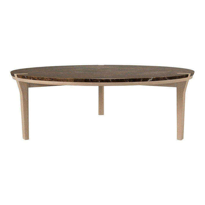 Round coffee table with a dark marble top and light wood legs, featuring a sleek, modern design.