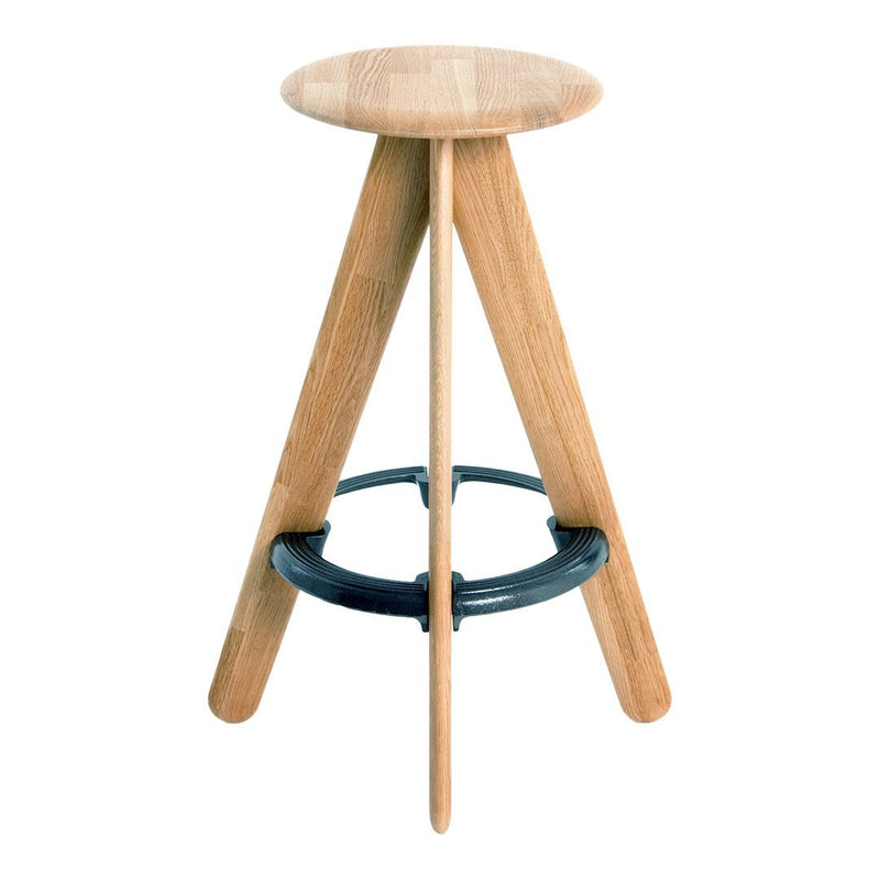 Natural wood stool with a light oak finish and black circular footrest, featuring a minimalist design.