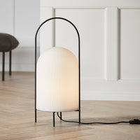 "White ribbed lampshade with black metal frame, featuring an elegant minimalist design."