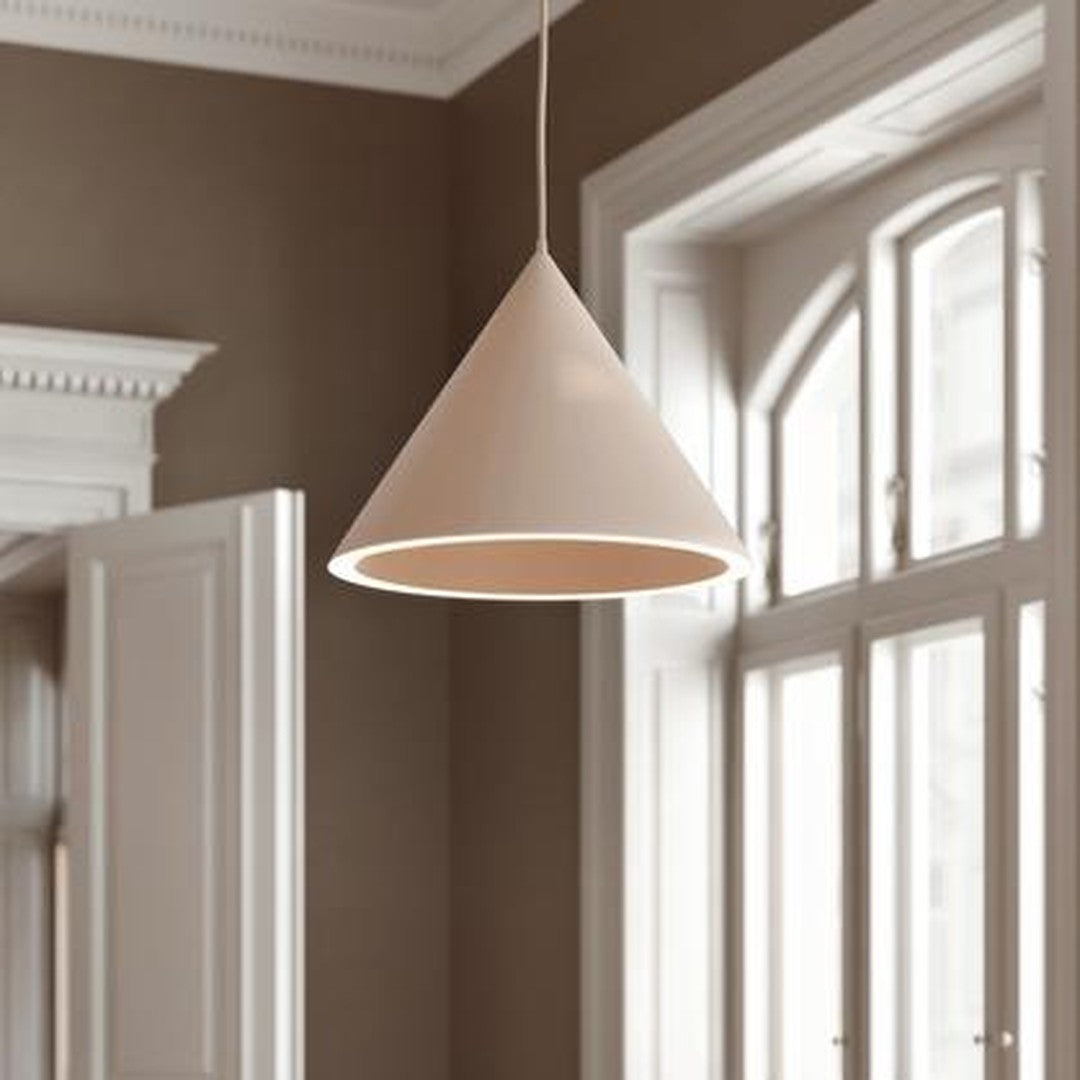 Beige cone pendant light against a warm brown wall, featuring a smooth surface and minimalist design.