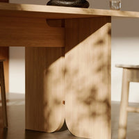 Light wood table with smooth grain, soft shadows, and natural hues creating a warm, inviting aesthetic.