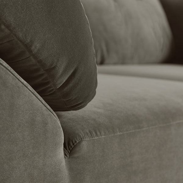 Soft brown fabric sofa with plush, textured cushions in a neutral color palette. Ideal for modern living spaces.