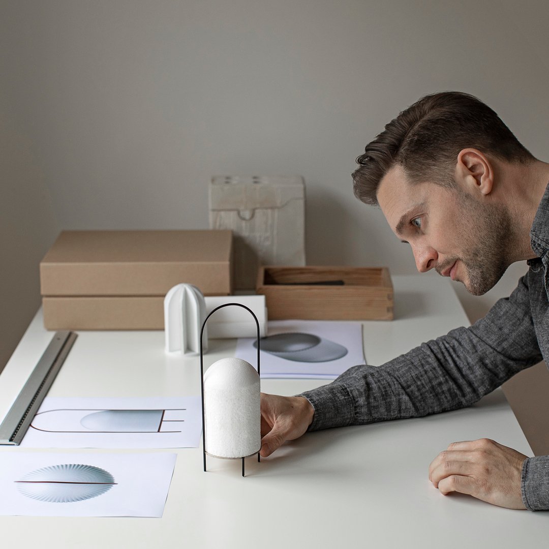 Modern design with soft white, grey, and neutral tones featuring minimalist patterns and textures on a workspace.