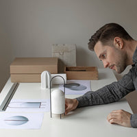Modern design with soft white, grey, and neutral tones featuring minimalist patterns and textures on a workspace.