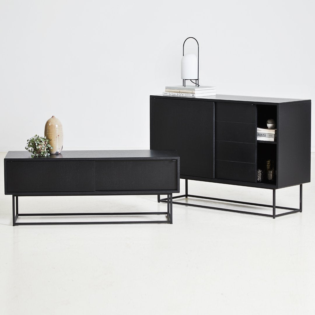 Sleek black furniture set featuring smooth surfaces and minimalist design, accented by bold metal frames and subtle textures.