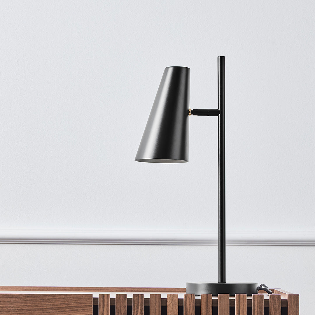 Sleek black metal desk lamp with a modern conical shade against a minimalistic white background. Perfect for contemporary decor.
