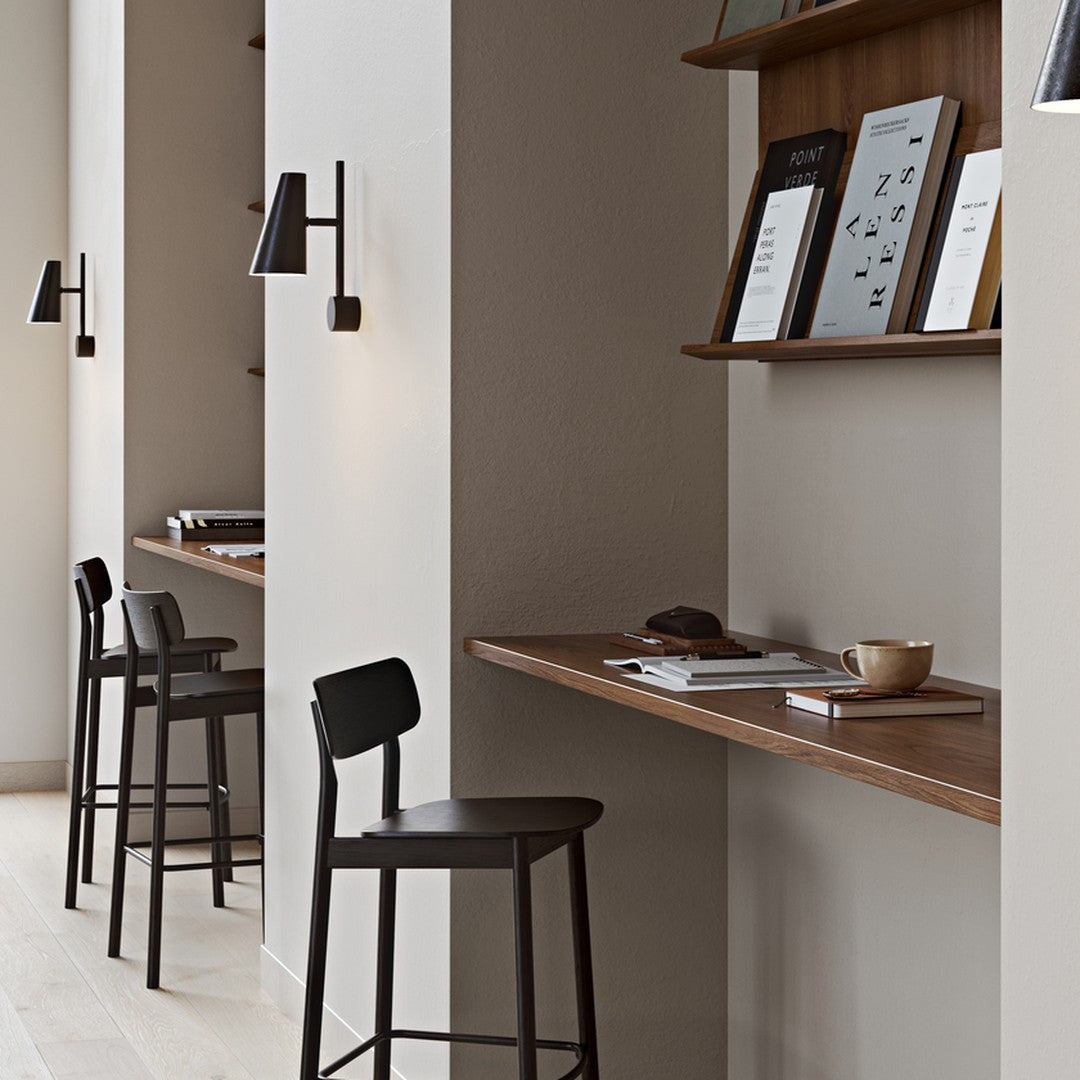 Modern workspace featuring warm wood tones, muted earth tones, and sleek black accents for a minimalist aesthetic.