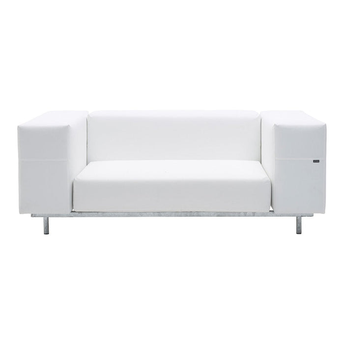 Modern white sofa with sleek lines and a minimalist design, featuring leather upholstery and metal legs.