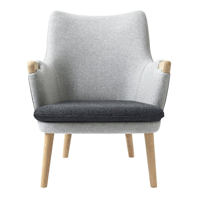 Gray and charcoal upholstered armchair with light wooden legs, featuring a sleek, minimalist design.