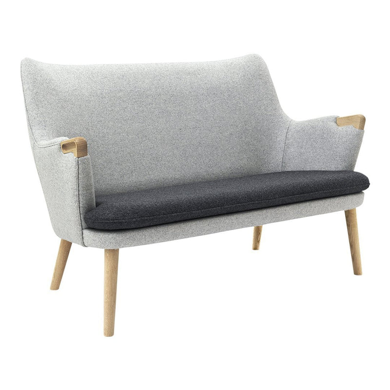Gray and black two-tone upholstered loveseat with light wood legs, featuring a smooth, textured finish.