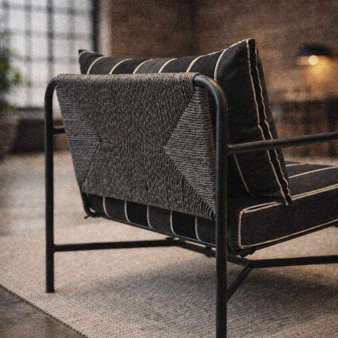 Stylish black and white striped chair with textured geometric patterns on the back and a sleek metal frame.