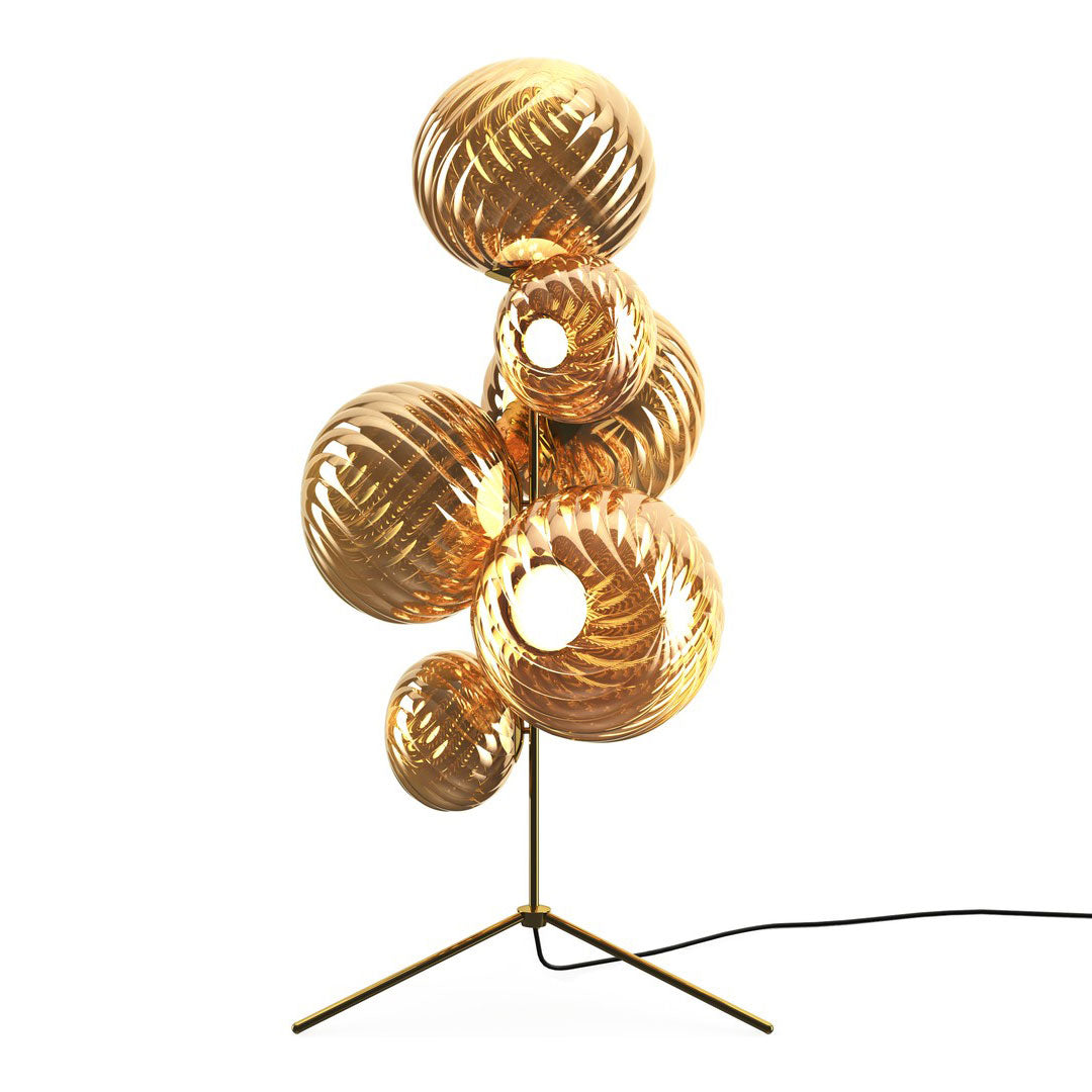 Gold and amber glass lamps with spiral patterns, creating an elegant, modern design for home decor.