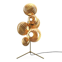 Gold and amber glass lamps with spiral patterns, creating an elegant, modern design for home decor.