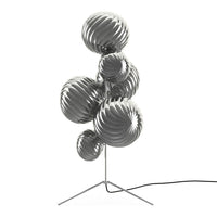 Silver and metallic spherical lamp with glossy, wavy patterns on a modern tripod base.
