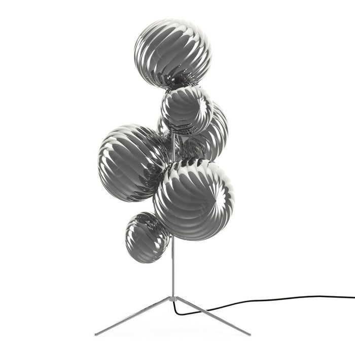 Silver and metallic spherical lamp with glossy, wavy patterns on a modern tripod base.