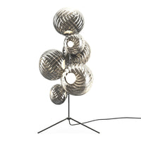 "Modern floor lamp with metallic spheres in shiny silver and black, featuring a stylish spiral pattern."