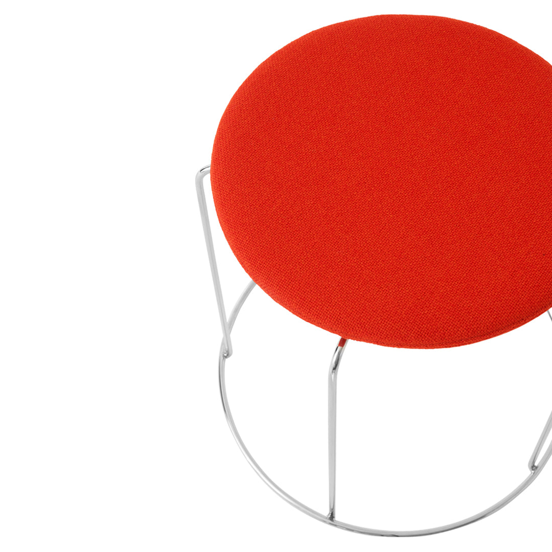 Bright red round seat with a sleek silver metallic base. Stylish and modern design, perfect for any space.