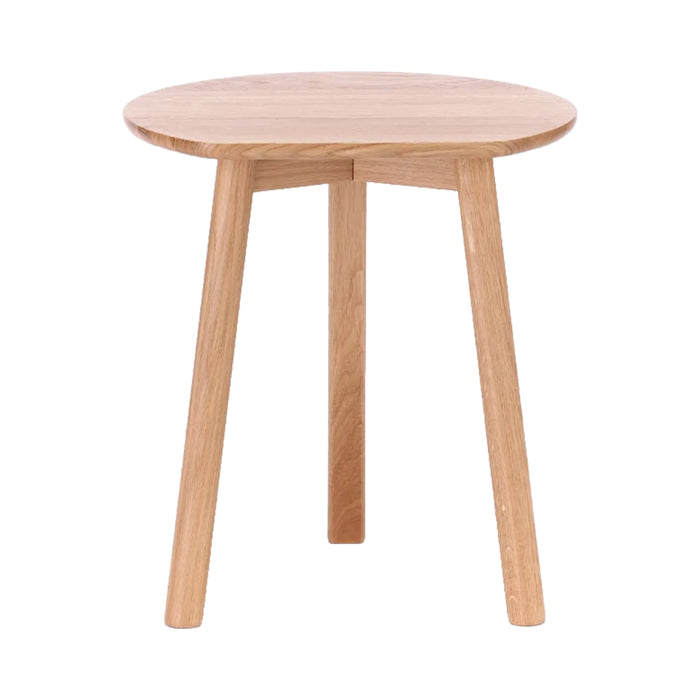 Natural wood round side table with a smooth finish and light oak color, showcasing minimalistic design and clean lines.