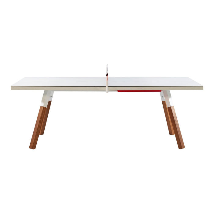 "Modern white table with warm wooden legs and red accent, featuring a sleek minimalist design."