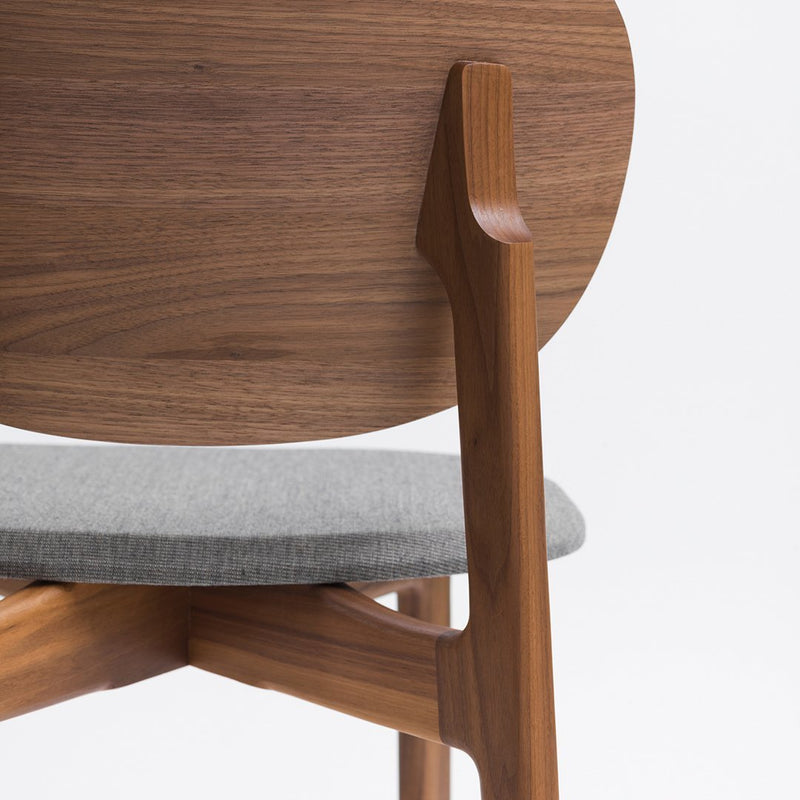 Wooden chair with a rich walnut backrest and soft gray upholstered seat, featuring clean, modern lines.