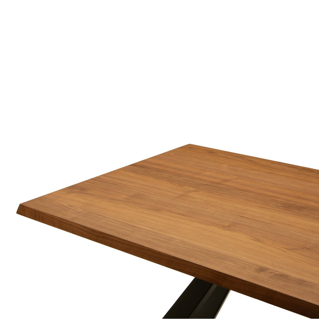 Natural wood tabletop in warm honey tones with a smooth finish and subtle grain pattern. Modern black metal legs.