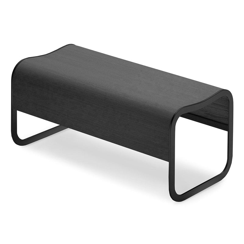 Sleek black minimalist bench with smooth curves and a matte finish, perfect for modern decor.