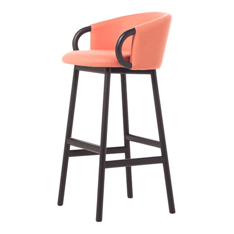 Coral upholstered bar stool with black wooden legs and curved armrests, featuring a smooth, modern design.