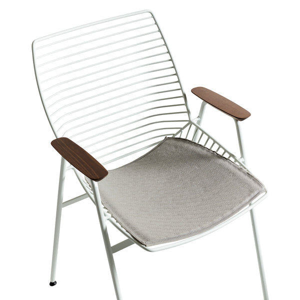 White striped metal chair with natural wood armrests and a light gray cushion, blending modern and minimalist design.