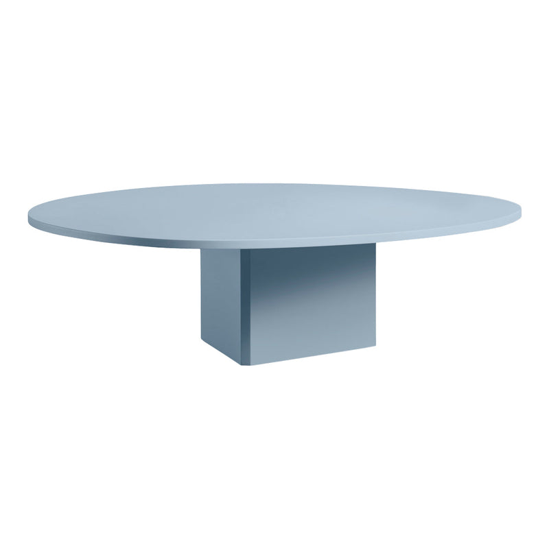 Round coffee table in soft blue with a minimalist design and a solid rectangular base.