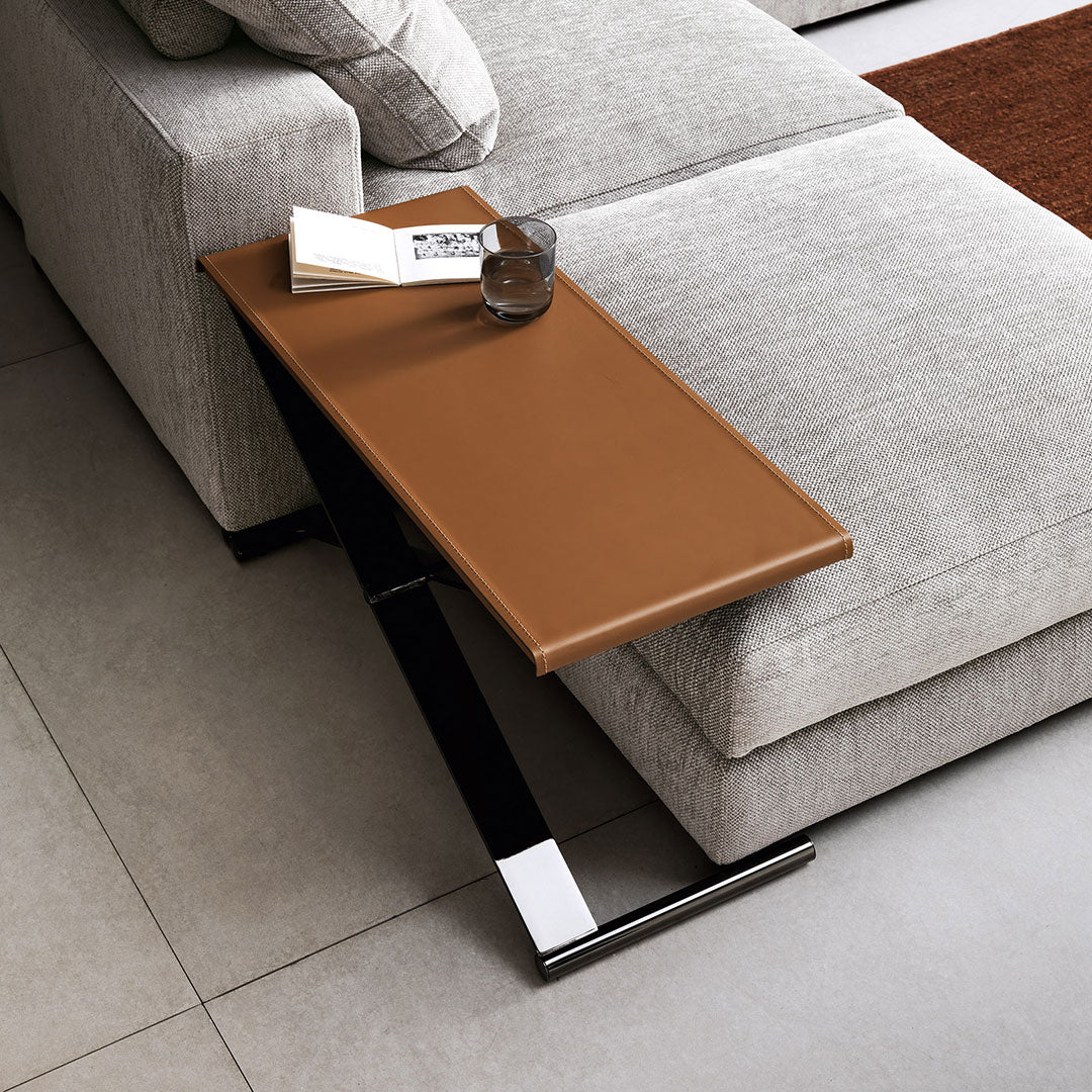 Brown faux leather side table with sleek black metal frame, complementing a contemporary living room aesthetic.