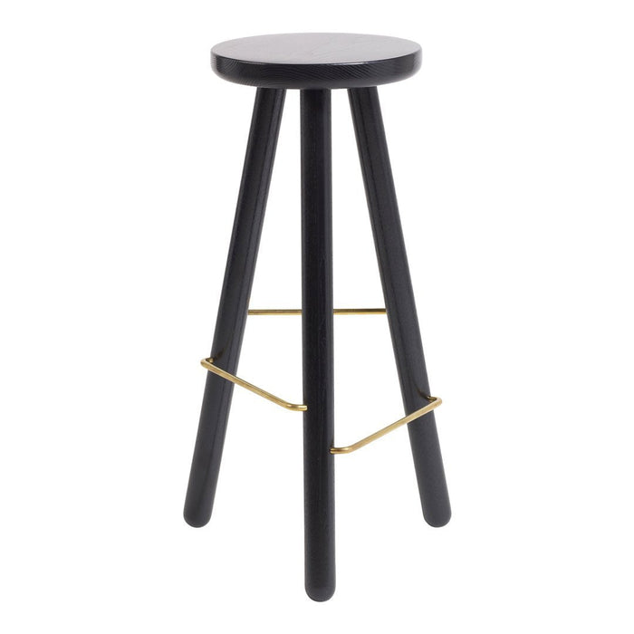 Black wooden stool with a round seat and gold metal footrest, perfect for modern decor.