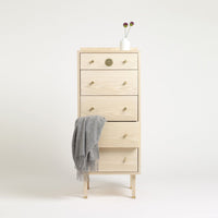 Light natural wood dresser with smooth, light grey accents and simple, stylish gold hardware.
