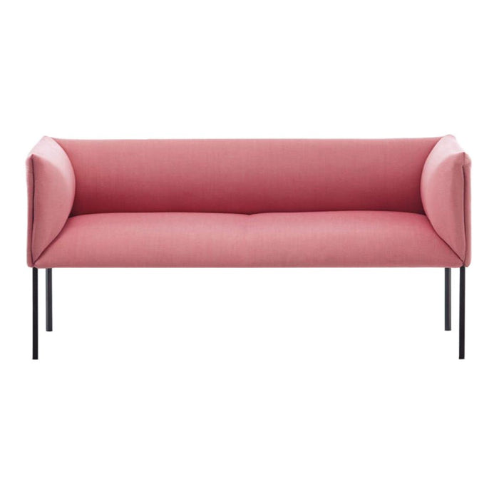 Pink upholstered sofa with sleek black legs, featuring a minimalist and modern design.
