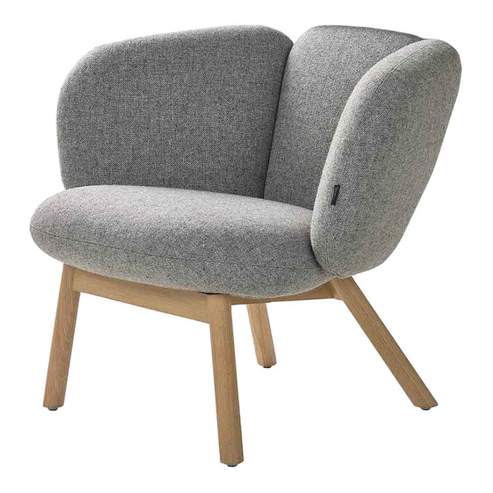 Soft gray fabric armchair with a contemporary shape and natural wood legs, featuring a minimalist design.