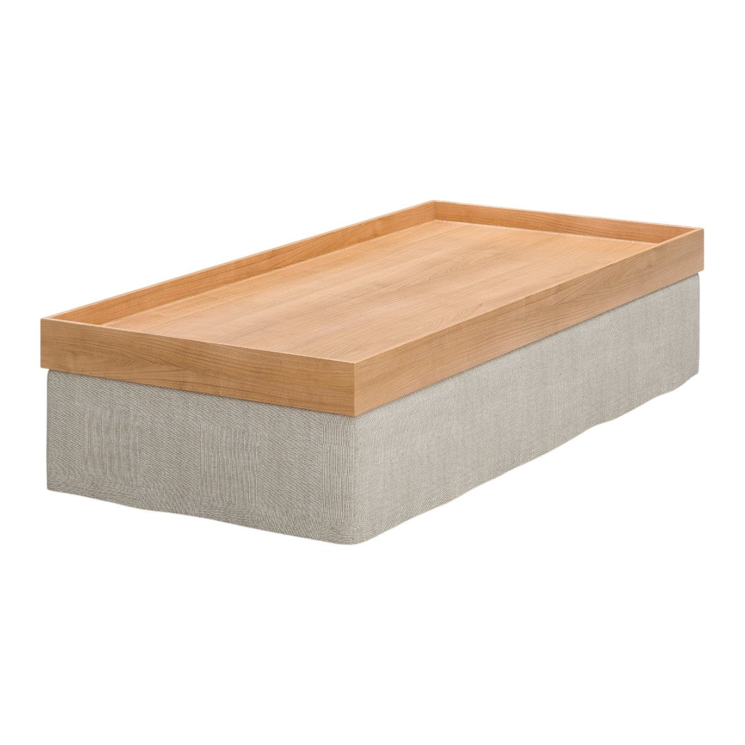 "Wooden tray in natural finish atop a beige linen-covered base, creating a stylish, minimalist design."