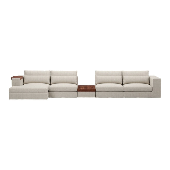 L-shaped sectional sofa in soft beige fabric, featuring plush cushions and a sleek wood accent table.