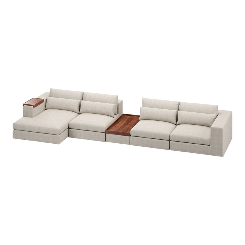 Beige sectional sofa with textured fabric and a wooden accent table, featuring clean lines and a modern design.