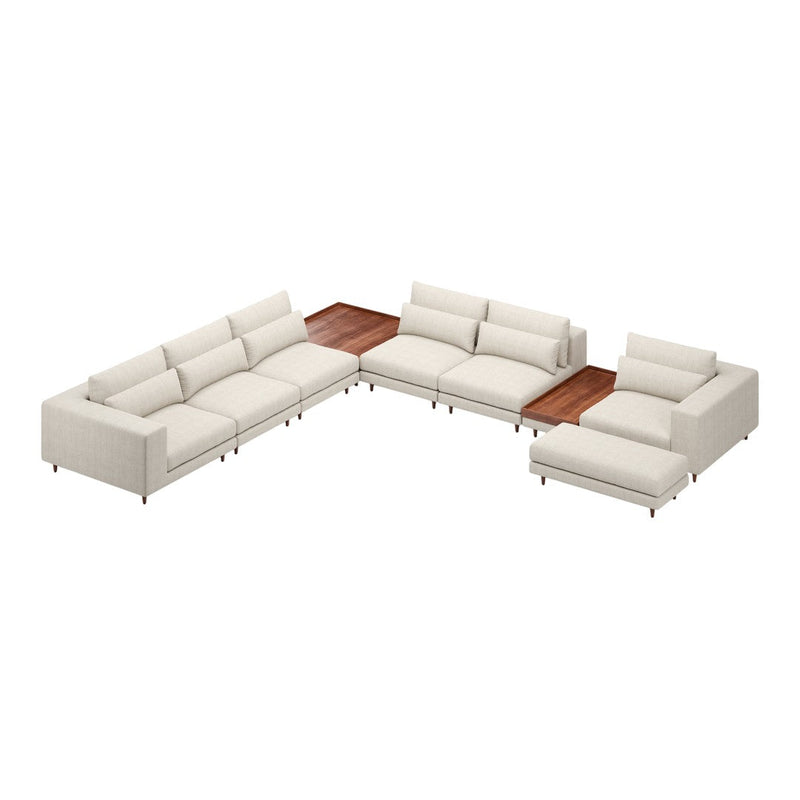 L-shaped sectional sofa in soft cream fabric with sleek lines and a wooden accent table. Modern and stylish design.