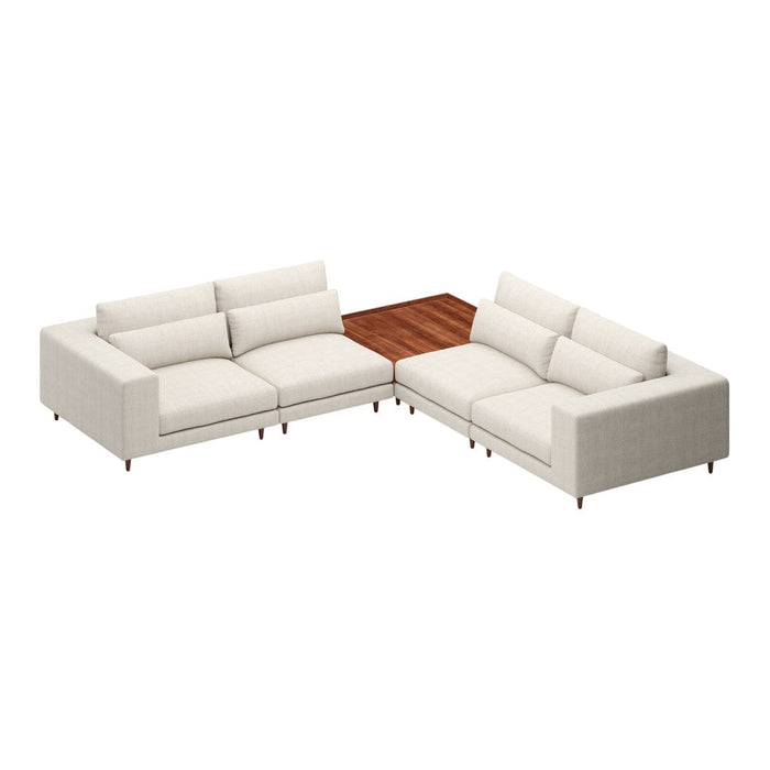 L-shaped sofa in soft beige fabric with a warm wooden table accent, featuring clean lines and minimalistic design.