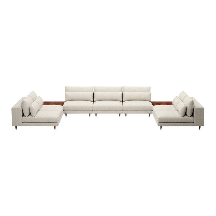 Cream-colored sectional sofa with smooth, clean lines and soft cushions. Elegant design complements modern décor.