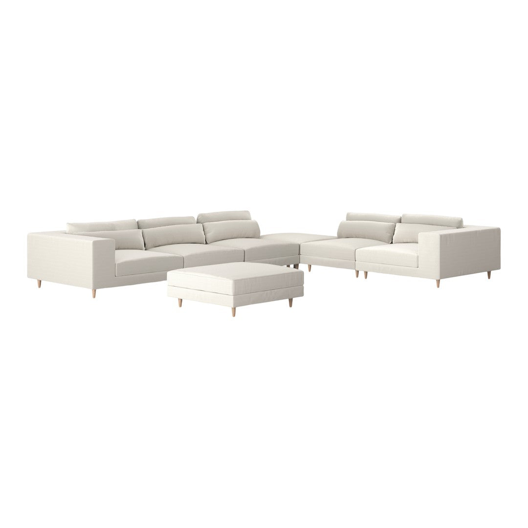 Modern white sectional sofa with clean lines and minimalist design, featuring light wood legs.
