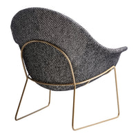 Black and white patterned chair with a gold metal frame, showcasing a modern and stylish design.