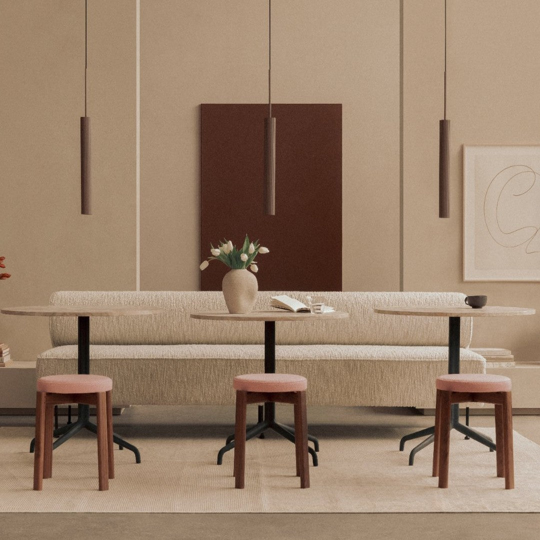 Neutral beige tones with deep brown accents; patterned soft seating paired with wooden stools in a modern setting.