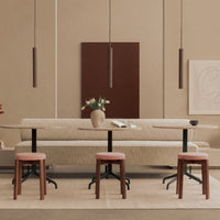 Neutral beige tones with deep brown accents; patterned soft seating paired with wooden stools in a modern setting.
