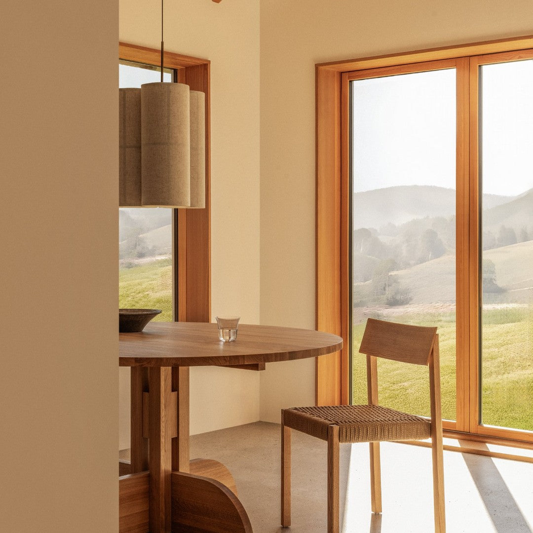 Natural wood tones and soft beige backdrop create a warm, modern aesthetic in this dining area.