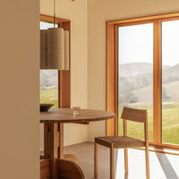 Natural wood tones and soft beige backdrop create a warm, modern aesthetic in this dining area.